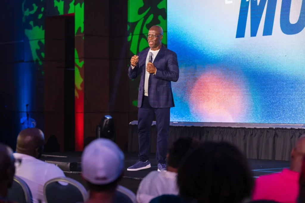 Mo Landy speaking to a crowded room